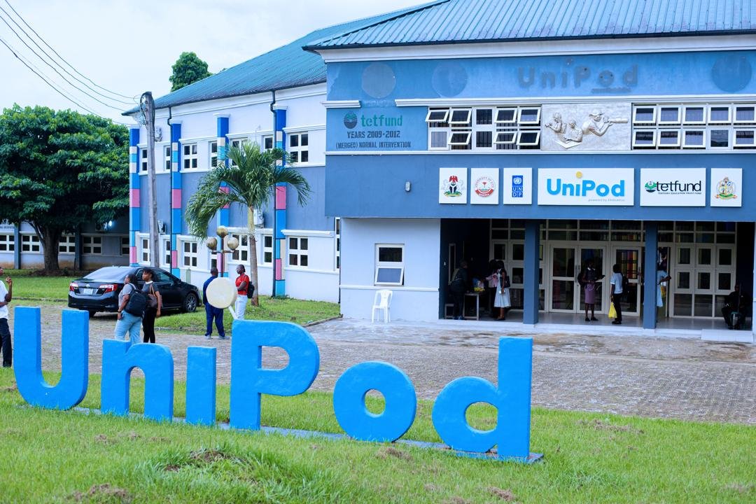 Blue UniPod letters on the lawn in front of the hub